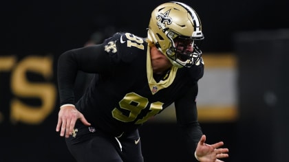 New Orleans Saints and former San Diego quarterback Drew Brees and General  Manager Mickey Loomis, right, hold a Saints jersey presented to Brees  during a news conference at the New Orleans Saints