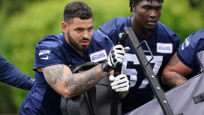 Seattle Seahawks linebacker Jon Rhattigan (59) arrives on the field along  with offensive tackle Jake Curhan (74) and defensive end Dre'Mont Jones  (55) before the NFL football team's mock game, Friday, Aug.