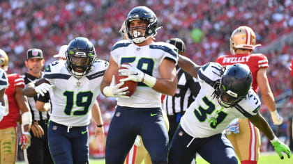 Seattle Seahawks linebacker Jon Rhattigan (59) arrives on the field along  with offensive tackle Jake Curhan (74) and defensive end Dre'Mont Jones  (55) before the NFL football team's mock game, Friday, Aug.