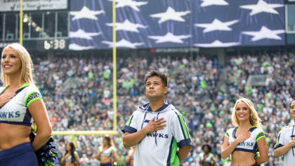 Fans cheer during an NFL Salute to Service ceremony during half time of an  NFL football game between the Seattle Seahawks and the Arizona Cardinals,  Thursday, Nov. 9, 2017, in Glendale, Ariz. (