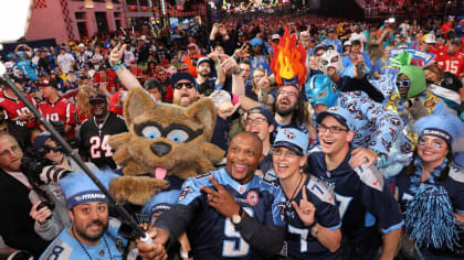 Former Tennessee Titans running back Eddie George, second from left, stands  with family members of the late Titans quarterback Steve McNair, as the  numbers for George and McNair are retired during halftime