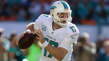 FILE - In this Oct. 14, 2018, file photo, injured Miami Dolphins  quarterback Ryan Tannehill cheers his team during the second half of an NFL  football game against the Chicago Bears, in