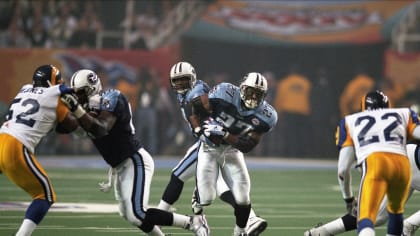 Former Tennessee Titans running back Eddie George, second from left, stands  with family members of the late Titans quarterback Steve McNair, as the  numbers for George and McNair are retired during halftime