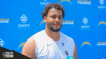 Los Angeles Chargers offensive tackle Rashawn Slater, left, works