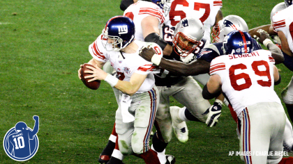 New York Giants quarterback Eli Manning escapes a sack by the New England  Patriots on fourth down and 6 during Super Bowl XLII at University of  Phoenix Stadium in Glendale, Arizona on