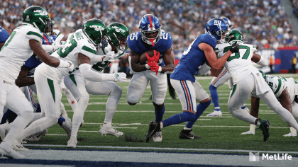 New Philadelphia Eagles' wide receiver Gary Ballman (85) goes down under  onslaught of New York Giants' safety Spider Lockhart (43) as the Giants'  defense man broke up a pass attempt in first