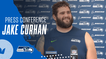 Seattle Seahawks linebacker Jon Rhattigan (59) arrives on the field along  with offensive tackle Jake Curhan (74) and defensive end Dre'Mont Jones  (55) before the NFL football team's mock game, Friday, Aug.