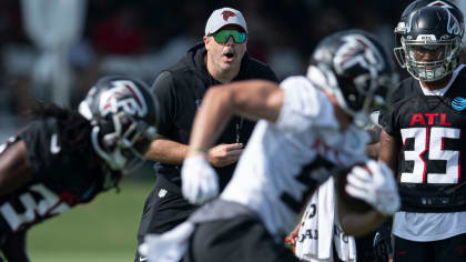 Atlanta Falcons quarterback Taylor Heinicke (4) high fives Atlanta Falcons  offensive lineman Ryan Neuzil (64) as they practice on the field before an  NFL pre-season football game against the Miami Dolphins, Friday