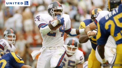 Rams' running back John Cappelletti, the former Heisman winner, is dragged  down by a shirt tackle as he tried to circle the New York Giants' left side  in Los Angeles Sunday, Sept.