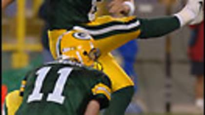 Green Bay Packers holder B.J. Sander watches as kicker Ryan