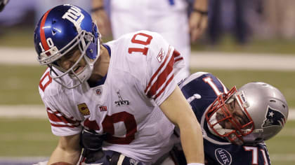 New York Giants wide receiver Victor Cruz (C) catches a two-yard touchdown  pass against New England Patriots safety James Ihedigbo during the first  quarter at Super Bowl XLVI at Lucas Oil Stadium