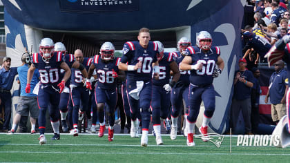 New England Patriots run onto the field prior to the first half of