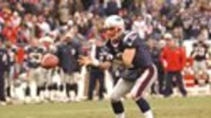 NFL quarterback Doug Flutie shows off his jersey during a ceremony