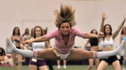 NFL cheerleaders perform a dance routine during a meet and greet