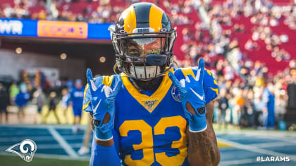 Download A Group Of Rams Players In Blue And Yellow Wallpaper