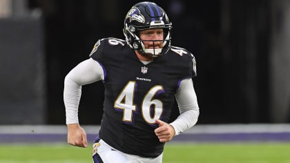 Baltimore Ravens long snapper Morgan Cox (46) waits to take the field while  holding a flag as part of the team's Salute to Service prior to an NFL  football game against the