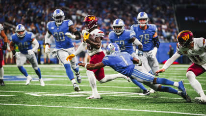 Players on the Washington Football Team run on the field ahead of the first  half of an NFL football game between the Washington Football Team and the  Detroit Lions in Detroit, Michigan