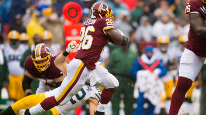 Washington Redskins running back Adrian Peterson (26) is tackled by  Carolina Panthers strong safety Eric Reid (25) in second quarter action at  FedEx Field in Landover, Maryland on October, 2018. The Redskins