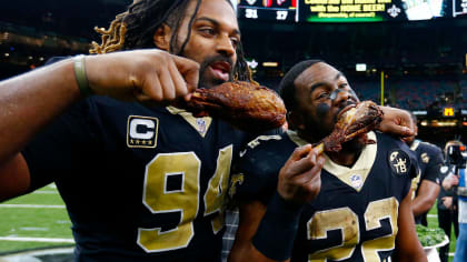 Officials stand near players during the playing of the national anthem  before the game between New Orleans Saints and Seattle Seahawks in the  first half of an NFL NFC wild card playoff