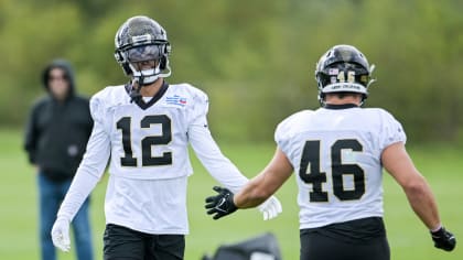 New Orleans Saints wide receiver Chris Olave wears his helmet