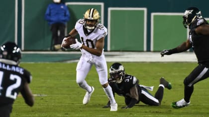 Taysom Hill New Orleans Saints Unsigned Carries The Ball in Black Jersey Photograph