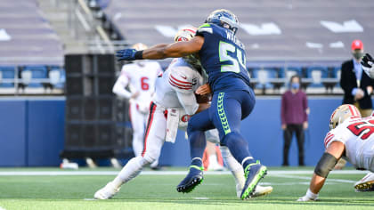 Logos for the NFL's Salute to Service event are posted on the field before  an NFL football game between the Seattle Seahawks and Arizona Cardinals,  Sunday, Nov. 21, 2021, in Seattle. (AP