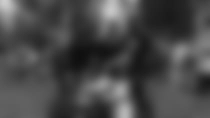 Cedric Ogbuehi (left) and Chris Okoye (middle) help Carlos Dunlap (right) and Michael Johnson celebrate back to school.