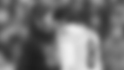 Cincinnati Bengals head coach Zac Taylor talks with Cincinnati Bengals quarterback Brandon Allen during the second half of an NFL football game against the Cleveland Browns, Sunday, Jan. 9, 2022, in Cleveland. (AP Photo/Nick Cammett)