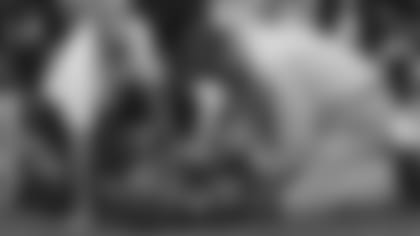 Head trainer Paul Sparling (left) and medical director Marc Galloway (right) attend to safety Shawn Williams.