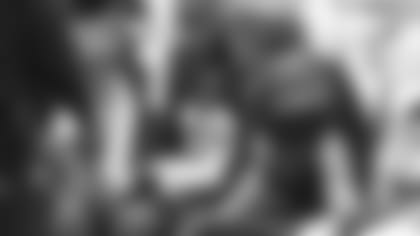 Bengals tackle Bobby Hart sits with guard Alex Redmond looking over offensive plays on a Microsoft Surface.