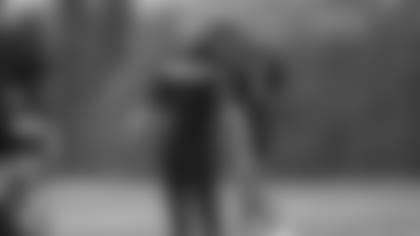 New DC Lou Anarumo talks it up with cornerback KeiVarae Russell.