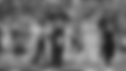 Cincinnati Bengals running back Joe Mixon (28) celebrates after a 3-yard touchdown during the first half of an NFL football game against the Cleveland Browns, Sunday, Dec. 29, 2019, in Cincinnati. Quarterback Andy Dalton (14) smiles as he looks on. (AP Photo/Bryan Woolston)