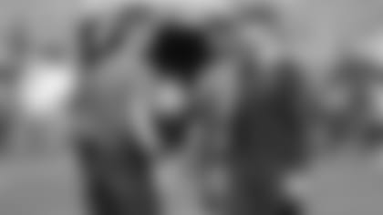 Cincinnati Bengals quarterback Joe Burrow, left, chats with Chicago Bears quarterback Andy Dalton, right, prior to an NFL football game, Sunday, Sept. 19, 2021, in Chicago. (AP Photo/Kamil Krzaczynski)