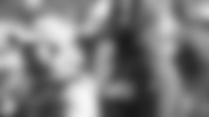 A.J. Green (right), next to director of player relations Eric Ball: Right where Ravens head coach John Harbaugh wants him.