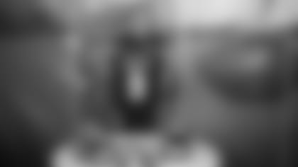 Quarterback Joe Burrow at Paul Brown Stadium holding up his game jersey after signing his rookie contract.