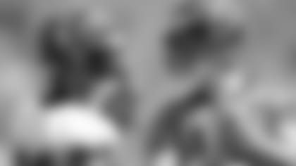 Joe Mixon (left) and Andy Dalton confer during practice.