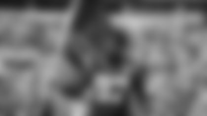 Carolina Panthers defensive end Mario Addison (97) runs out onto the field with an American flag before an NFL football game against the Atlanta Falcons, Sunday, Nov. 17, 2019 in Charlotte, N.C. (NFL Photos via AP)