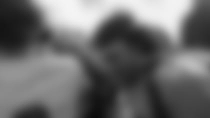 After giving his speech, Phillip Lindsay puts his hand in the huddle with the rest of West High School's football team.