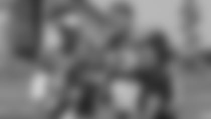 Garett Bolles, along with his wife, Natalie, and his son, Kingston, take a photo with Bears QB Mitchell Trubisky.