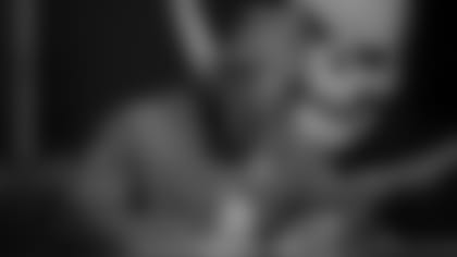 Running back Leonard Fournette of the Tampa Bay Buccaneers signs his contract at AdventHealth Training Center