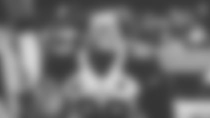 DL J.J. Watt (black and white photo) sits on the bench before a playoff game in L.A. in 2021