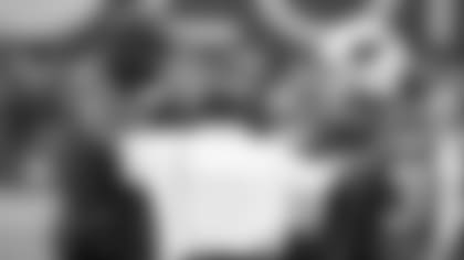 From left: Offensive coordinator Byron Leftwich, running backs coach Kirby Wilson and running back David Johnson talk on the sideline