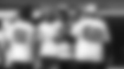 Wide receiver DeAndre Hopkins (10) gets a welcome back fist bump from tackle Kelvin Beachum (68) as Hopkins returned to the practice huddle for the first time since his suspension ended.