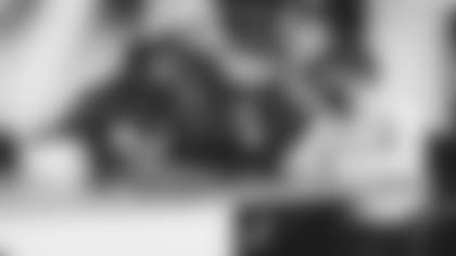 WR A.J. Green (left) signs his contract alongside owner Michael Bidwill.