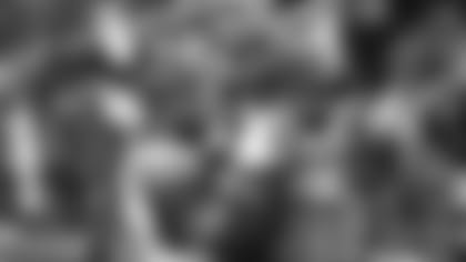 Linebacker Chandler Jones signs an autograph following a training camp practice in 2018.