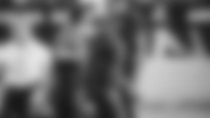 Quarterback Kyler Murray walks off the field with head athletic trainer Tom Reed at the end of the Cardinals' loss to the Packers on Thursday.