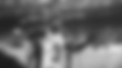 Safety Budda Baker gives an on-field interview after the Bears game in Chicago.