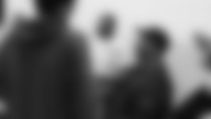 Former Cardinals defensive lineman Michael Bankston gives a kid a good-natured side-eye about his favorite NFL team during a Thanksgiving dinner for foster children earlier this week.