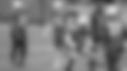 With new running backs Alfred Morris (36) and Zach Zenner (22) looking on, Chase Edmonds (29) and practice-squad running back Justin Davis go through a drill at Wednesday's practice.