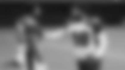 Defensive tackle Corey Peters (98), here showing a technique to rookie Rashard Lawrence, said the Cardinals players are discussing various ways to protest racial inequality on the heels of boycotts in other professional leagues.